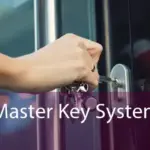 Close-up of a hand inserting a key into a door lock, illustrating a master key system for controlled access in commercial or office buildings."